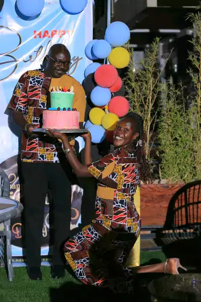 honourable_evelyn_anite_giving_cake_to_husband