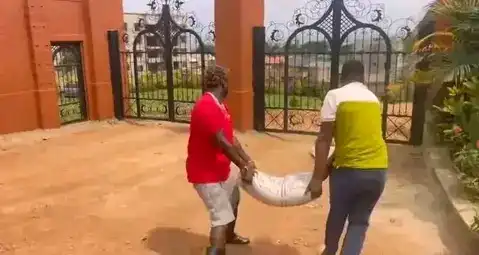 Gravity Omutujju with his two bags of cement and sand